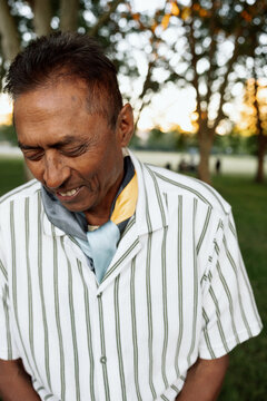 Candid portrait of mature man in park with thoughtful expression