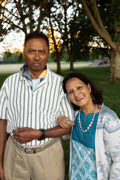 Mature couple portrait sharing a candid moment in park