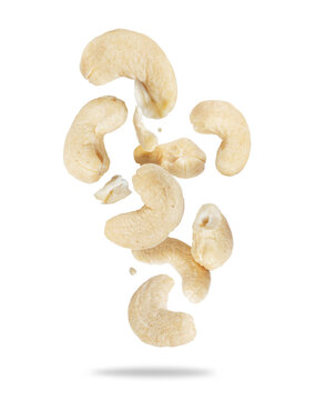 Group of tasty cashews in the air close-up on a white background