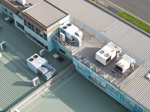 Aerial view of industrial factory rooftops featuring multiple HVAC units and ventilation systems in Melbourne, VIC, Australia.