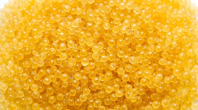 Full frame seamless texture pattern of shiny golden yellow caviar pearls for molecular gastronomy fine dining garnish isolated on transparent background. 