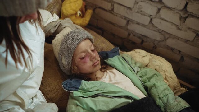 Close up of injured refugee girl lying unconscious on old mattress inside abandoned building, bruises marking her pale weak face symbolising despair and fragile survival after post apocalypse
