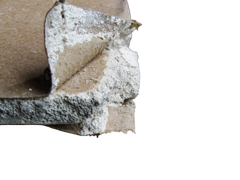 Folded and torn cardboard with white foam insulation layers, damaged packaging