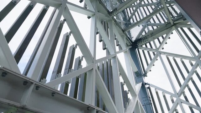 Low-angle view of modern architectural steel framework and wooden slats
