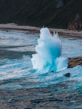 Aerial view of the powerful ocean waves crashing against the rugged cliffs at The Gap in Torndirrup, Western Australia, Australia.