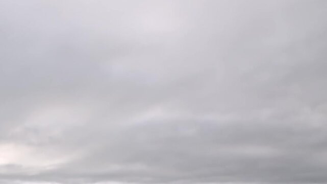 Layered overcast clouds fill the sky in soft gray coastal light. Visible details include minimal framing, while the wider composition emphasizes natural texture and depth.