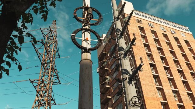 Scenic view of electricity pylons stretching on a street with sky and clouds background.
