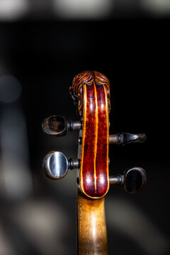Lion-head scroll and tuning pegs of a Baroque violin