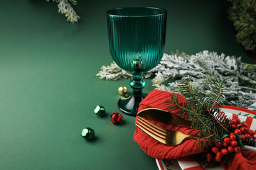 Festive Christmas composition with decorative tableware and green glass creating a stylish background for invitations, seasonal promotions and holiday greetings © svittlana