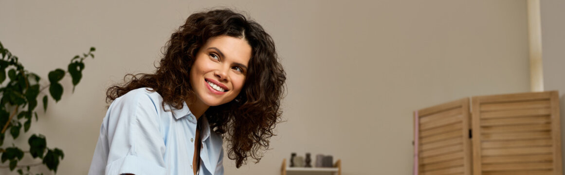 Young woman embraces work life balance in a cozy home environment, banner