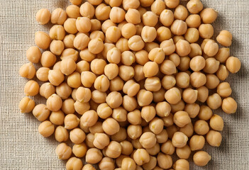 Fototapeta premium Healthy plant based protein, raw organic chickpeas for vegan nutrition and sustainable food sources on a textured linen background