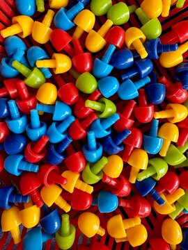 Colorful plastic pegboard pins background for children early development and fine motor skills.