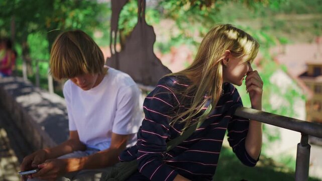 Teenagers experiencing digital isolation and social awkwardness as the boy uses his phone while the girl feels ignored, highlighting modern relationship challenges