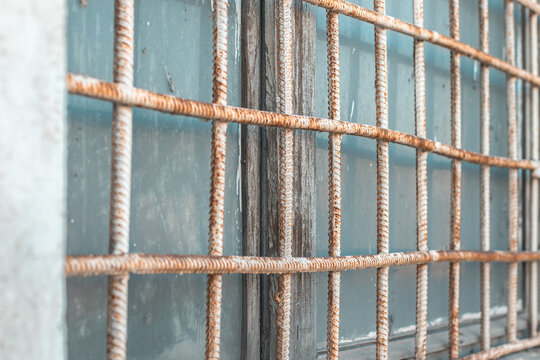 Vintage Window with a Tarnished Metal Grate.