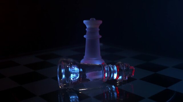 Cinematic 360 rotation around a standing glass queen and a defeated king piece, symbolizing checkmate, victory, and power loss.
