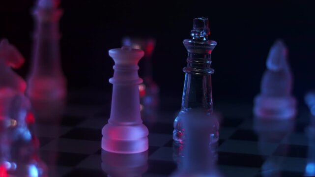Conceptual macro rotation focusing on a king and queen ready for strategic conflict, framed by surrounding glass pieces in dramatic neon light.