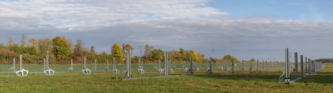 Authentic photography capturing the first stage of a large-scale solar park project. A powerful visual symbol of the real, tangible transition toward clean energy under an expansive sky.