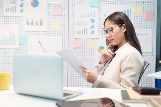 Successful Businesswoman Reviewing Business Report