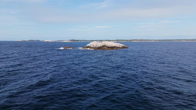 Aerial cinematic footage of the maritime landscape off Prospect, Nova Scotia, Canada, featuring scattered rocky islands, rugged shorelines, and the open Atlantic Ocean.