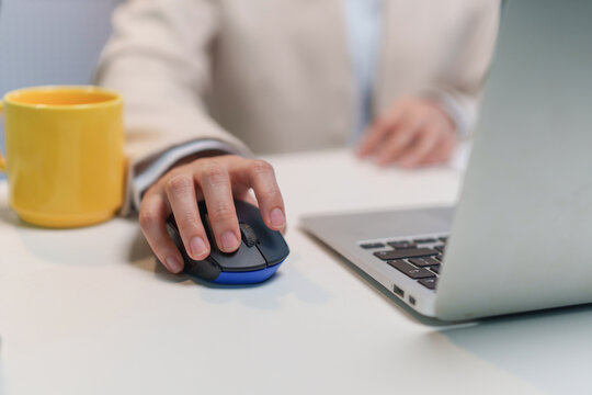 Business Professional Using Computer Mouse and Laptop