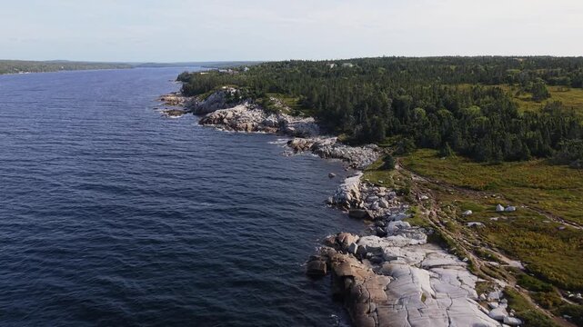 Wide cinematic drone shot of the Atlantic coastline in Prospect, Nova Scotia, featuring rocky coastal terrain, ocean waves, and expansive maritime landscapes.