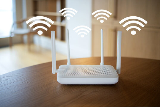 White wireless router with four upright antennas and floating wifi symbols on a wooden table in a softly blurred contemporary home interior