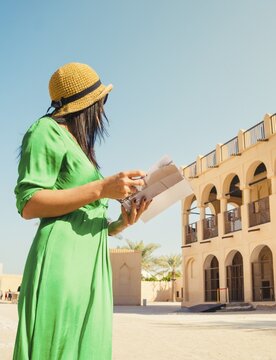 Doha, Qatar - 15th january, 2026: woman tourist stand by National Museum Qatar Doha old palace architecture traditional Qatari heritage historic building arches tourism Middle East culture