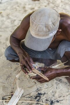 Man of the Orang Asil starting a fire, Taman Negara, Malaysia