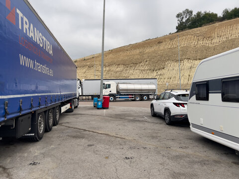 Vic, Spain; August 22 2026: Trucks and caravan parked at service area in Gurb