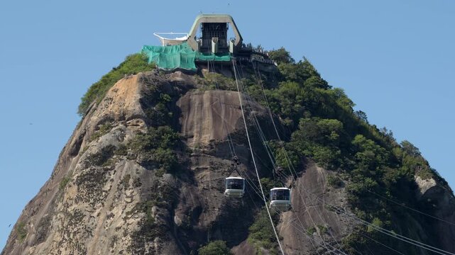 Cable cars passing in opposite directions between Morro da Urca and Sugarloaf Mountain, Rio de Janeiro, Brazil.