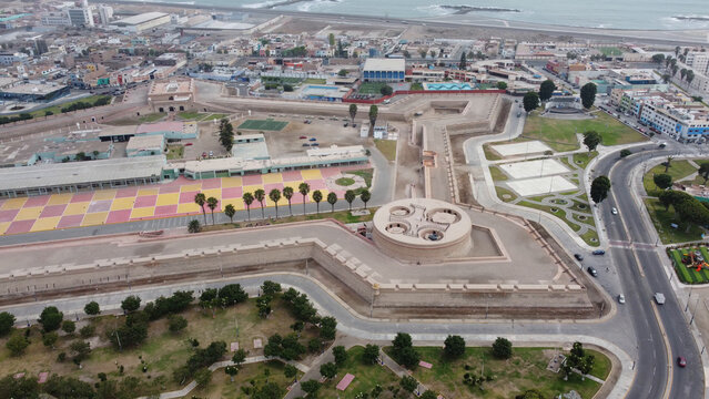 Aerial view of Real Felipe Fortress, a historic pentagonal military fortification, surrounded by urban streets, green spaces, and the Pacific coastline in Callao, Callao Region, Peru.