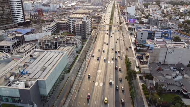 Aerial view of the busy highway with modern urban buildings and traffic flow in La Molina, Lima Province, Peru.