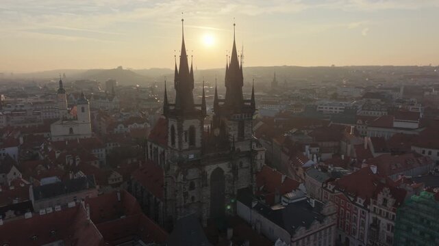 flying clockwise around backlit Our Lady Before Tyn Church in Prague