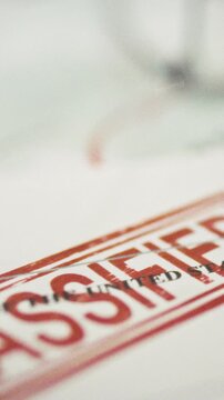 A red ink stamp marks confidential government documents on a table during diplomatic negotiations, emphasizing security protocols and interstate agreements for official state records