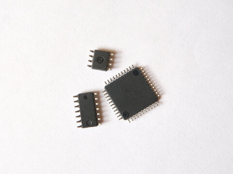 Microchip or integrated circuits on white background. High technology semiconductor components