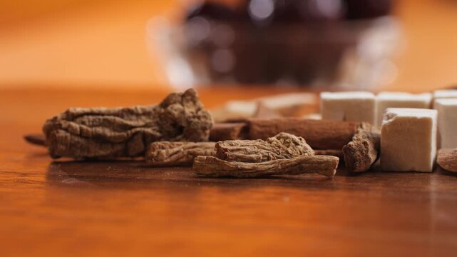 Chinese herbal soup ingredients Shi Quan Da Bu Tang, close up of ten dried herbs, poria cubes, licorice, astragalus and angelica root, traditional Chinese medicine tonic