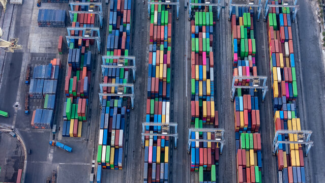 Aerial view of Pelabuhan Tanjung Emas showing rows of colorful shipping containers stacked in the port terminal in Semarang Utara, Central Java, Indonesia.