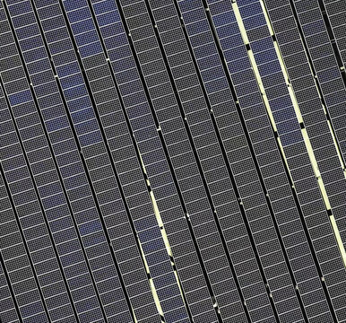 Aerial view of solar panel array with rows of photovoltaic modules arranged in a grid pattern in Los Angeles, California, United States.