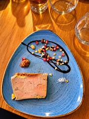 Gourmet Foie Gras with Pomegranate and Nuts. Elegant slice of foie gras beautifully plated with pomegranate seeds, toasted nuts, fruit chutney, and a decorative balsamic glaze. © Videoframe Stock