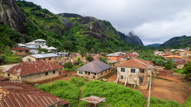 Aerial view of Idanre Hills with traditional houses, lush green vegetation, and rocky terrain in Idanre, Ondo, Nigeria.
