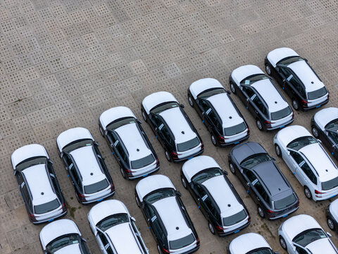 Aerial view of rows of parked cars in a large paved parking lot in Gdansk, Poland.