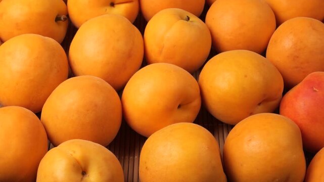 Fresh ripe apricots moving in slowly moving