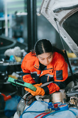 Focused ev repair shop ev car ev mechanic professional woman technician works with serious emotion...