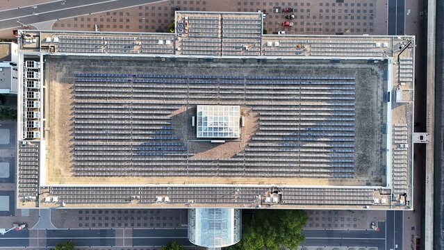 Aerial view of Messe Frankfurt featuring a large rooftop covered with rows of solar panels and a central glass skylight in Frankfurt am Main, Hessen, Germany.