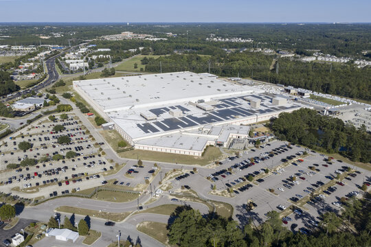 Aerial view of the Trane Technologies facility featuring a large industrial building with a white roof, expansive parking lots, and surrounding woodland in Columbia, South Carolina, United States.