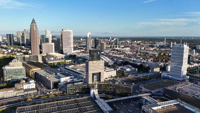 Aerial view of Messe Frankfurt exhibition grounds and the surrounding modern skyscraper skyline in Frankfurt am Main, Hessen, Germany.