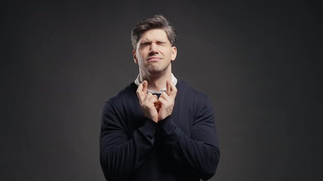 Handsome Man Crossing Fingers. Praying With Hopeful Expression, Silently Prays. Luck, important results, business risks