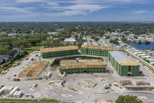 Aerial view of the Hanover Gateway construction site featuring multi-story buildings with wooden framing and green sheathing in Pinellas Park, Florida, United States.