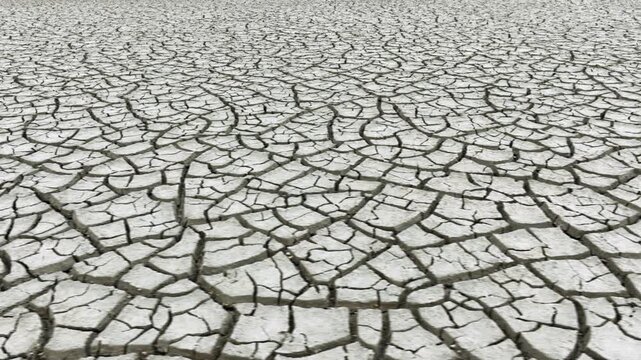Aerial shot looking down at the cracked surface of a dry lake.