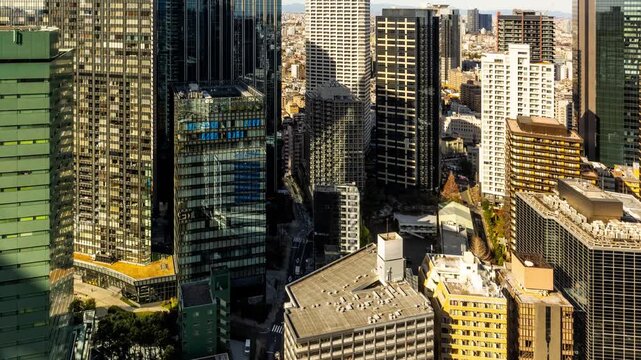 Time Lapse of morning light and shadows moving across the skyscrapers of Shinjuku, one of the wards of Tokyo Japan.